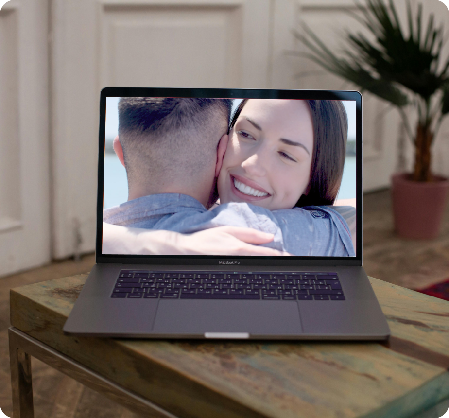 A laptop displays a video produced by The Quentosity Group.