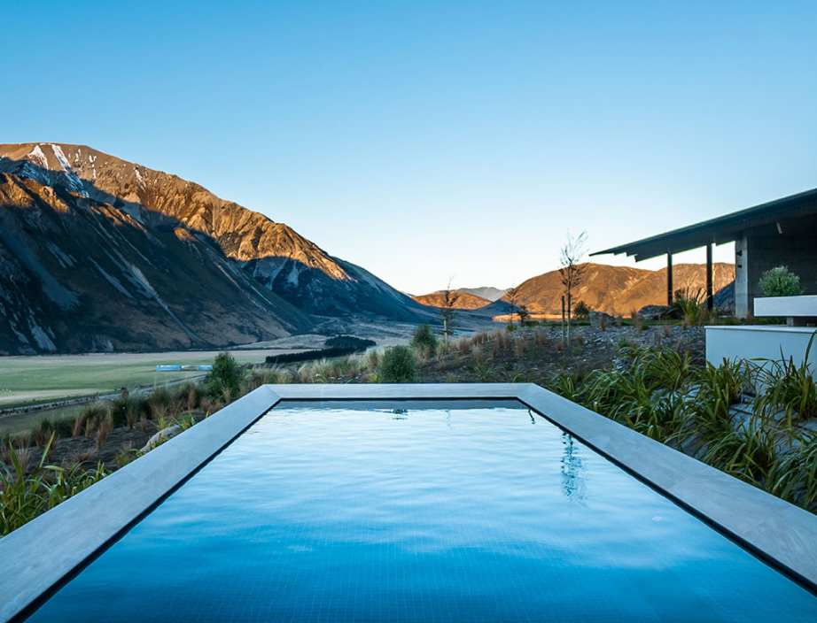 A pool in the foreground of a valley and mountains.