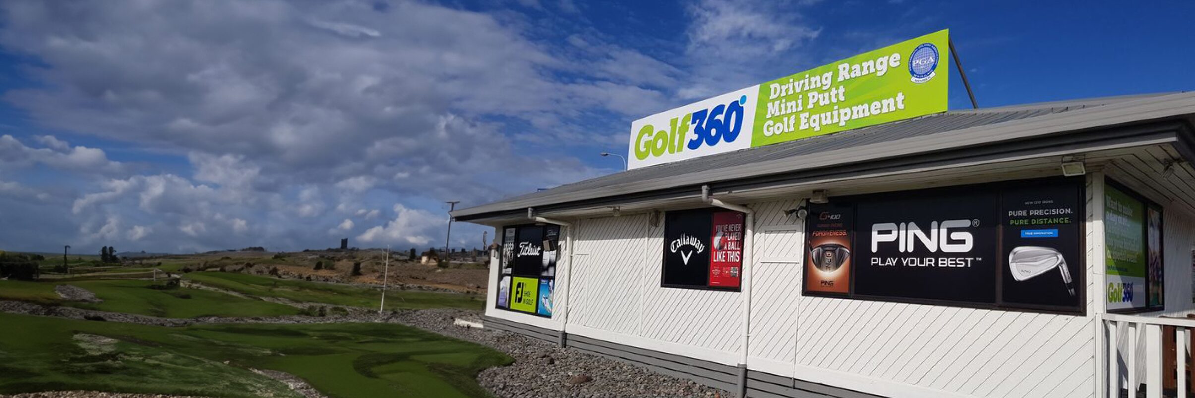 Golf 360's mini putt range next to the store building.