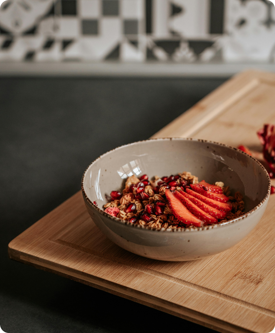 Granola and sliced stawberries in a bowl.