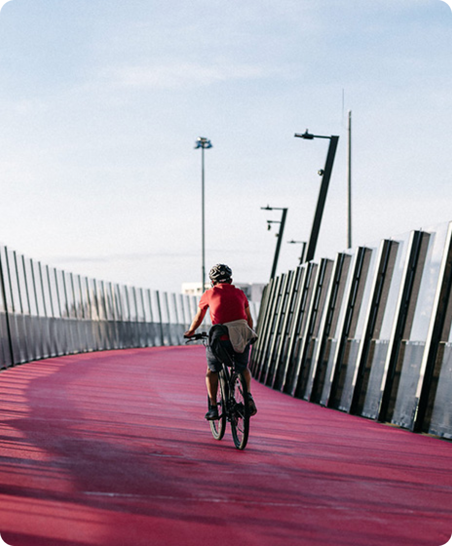 A bicyclist rides across a bridge.