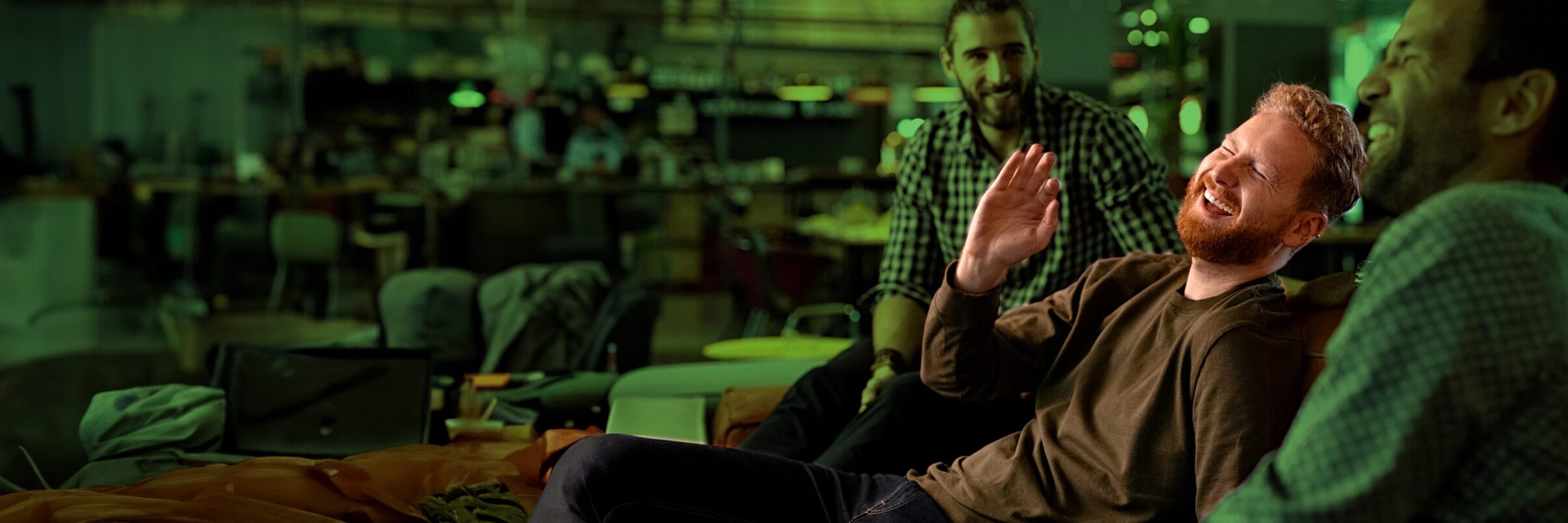 Three men laughing in the office.