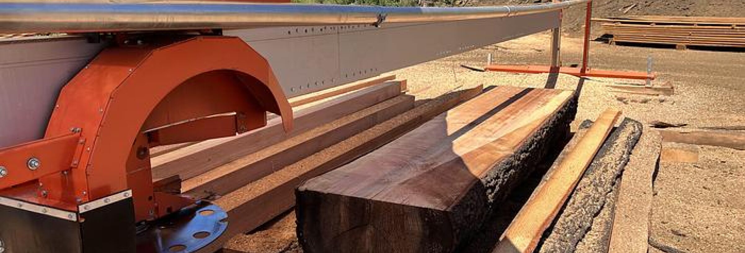A portable sawmill cuts timber into usable lengths of wood.